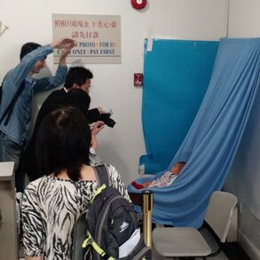 A baby has her passport photo taken while her proud parents get their own shot