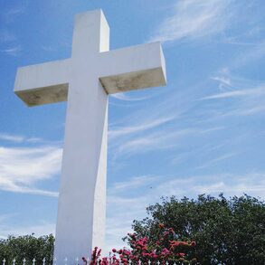 A cross adorns the peak of Mount Helix