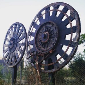 A sculpture made out of 2 large gears near a train station in San Francisco's Dogpatch district
